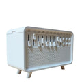 White geometric 3-in-1 Bluetooth speaker, white noise machine, humidifier, and night light unit on a surface