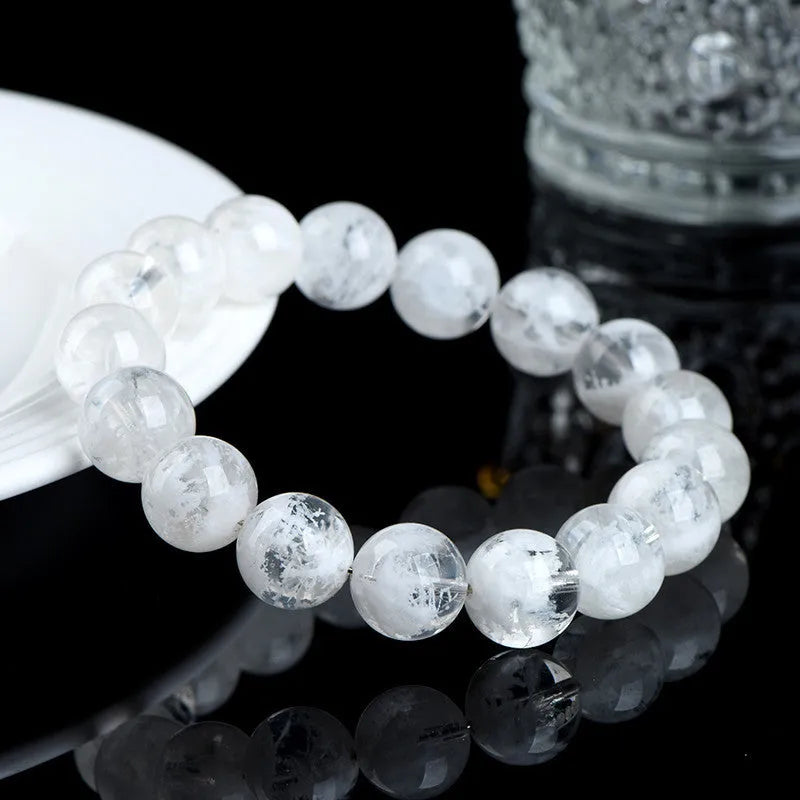 Women's crystal bracelet with round snowflake beads and a traditional Ruyi charm.
