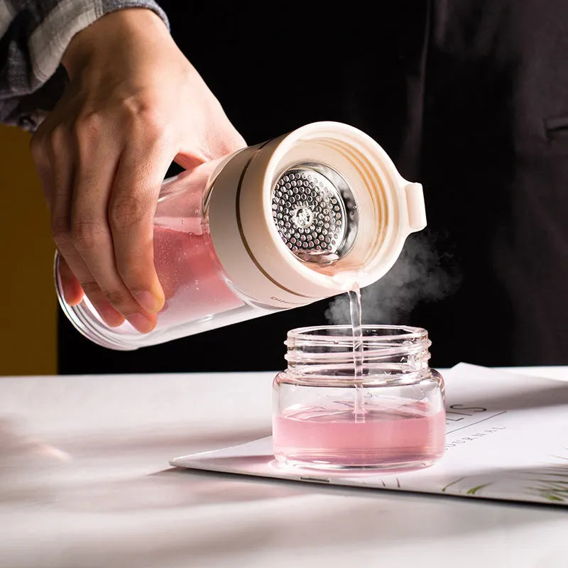 Glass water bottle with tea infuser filter showing double wall construction and portable rope