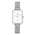 Women's rose gold waterproof quartz watch with woven steel strap on wrist.