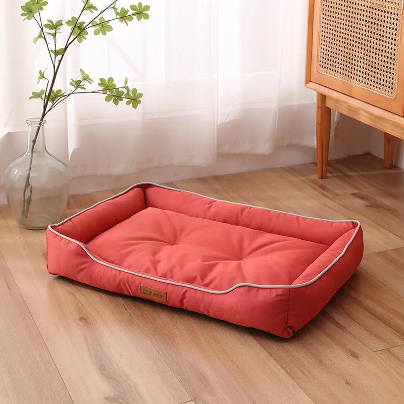 Grey waterproof dog sofa bed with a soft cushion, shown next to a sleeping golden retriever.
