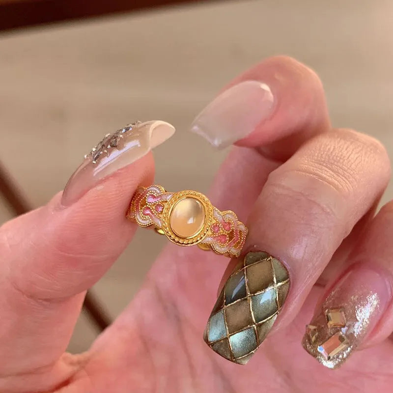 Geometric open mouth ring with pink crystal enamel detailing on copper gold plated band