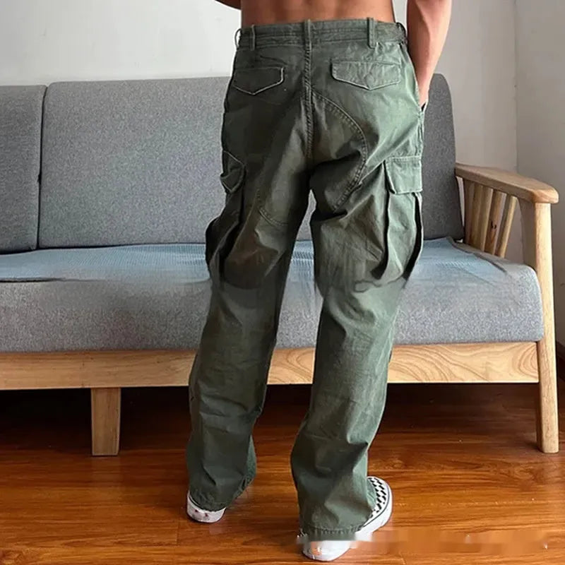 Men's loose fit washed cotton paratrooper pants in Army Green with large pockets, flat lay