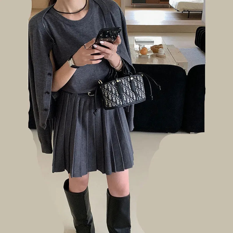 Women's grey art retro two-piece set with pleated vest skirt, adjustable belt, and long-sleeved knitted cardigan.