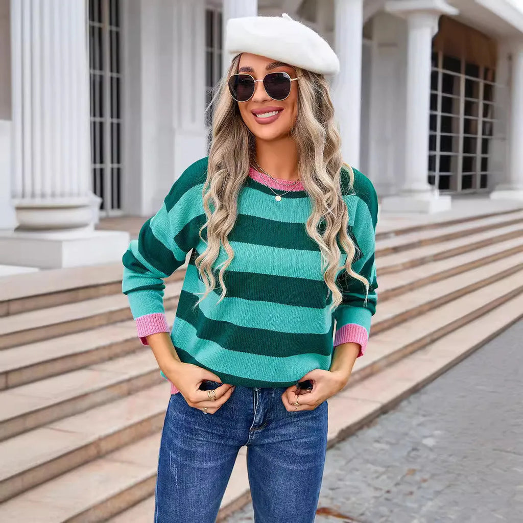 Women's loose blue acrylic sweater with stripes, round neck, and long sleeves on a hanger.