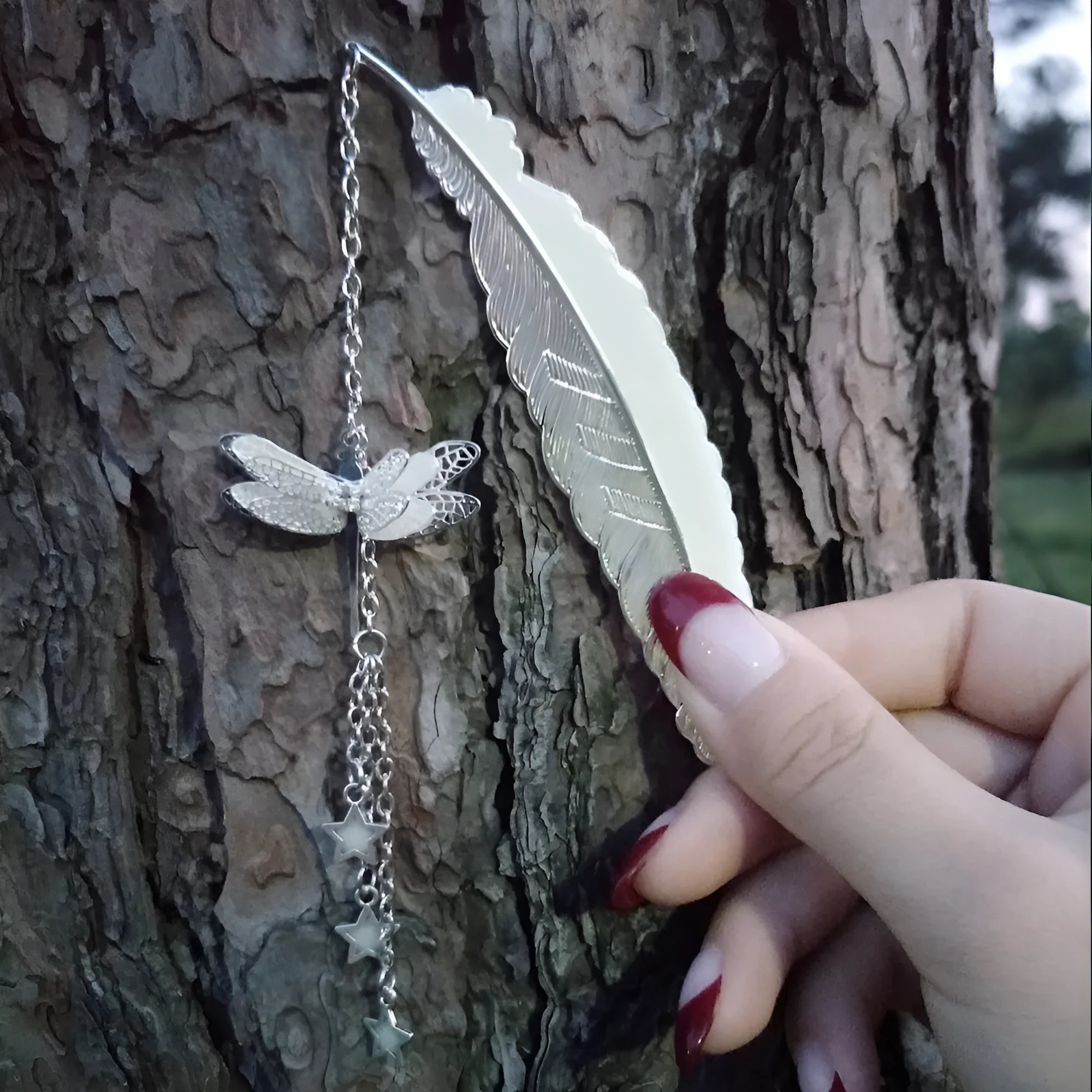 Luminous retro pure copper feather metal bookmark with glow-in-the-dark design showing silver feather and celestial accents