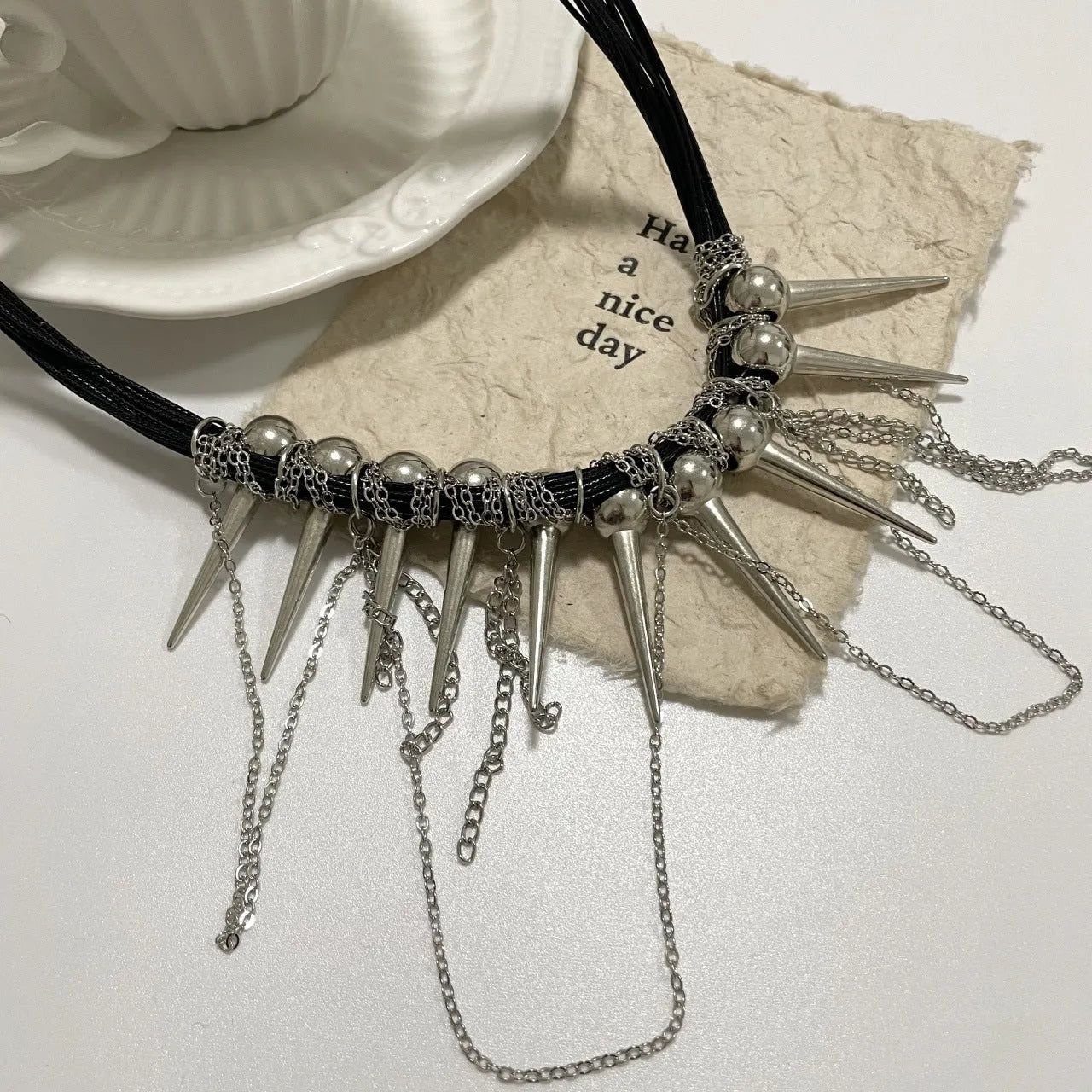 Leather necklace with winding tassel, round beads, and point rivet detailing for women