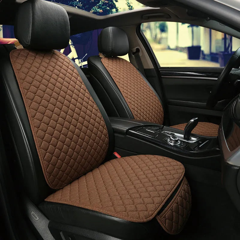 Linen universal car seat cushion in black with decorative red thread pattern on base.