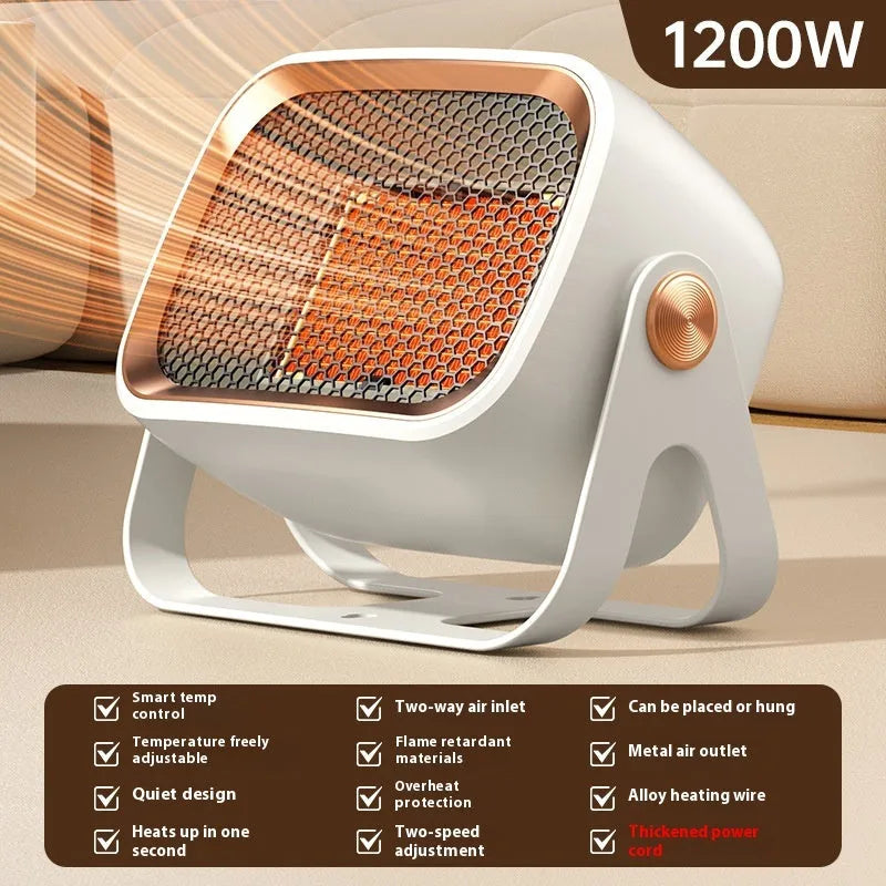A compact grey desktop ceramic electric heater with a rotatable base on a wooden desk.
