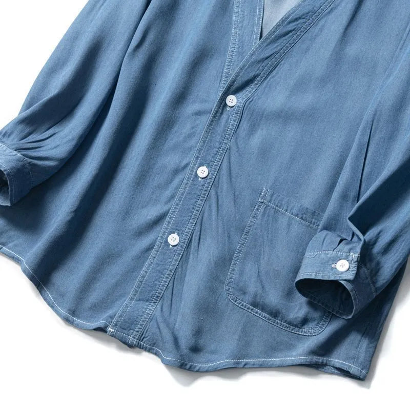 Men's dark blue three-quarter sleeve V-neck casual denim coat laid flat.
