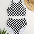 Women's backless racing swimsuit with shoulder suspender strap in black and white chessboard pattern