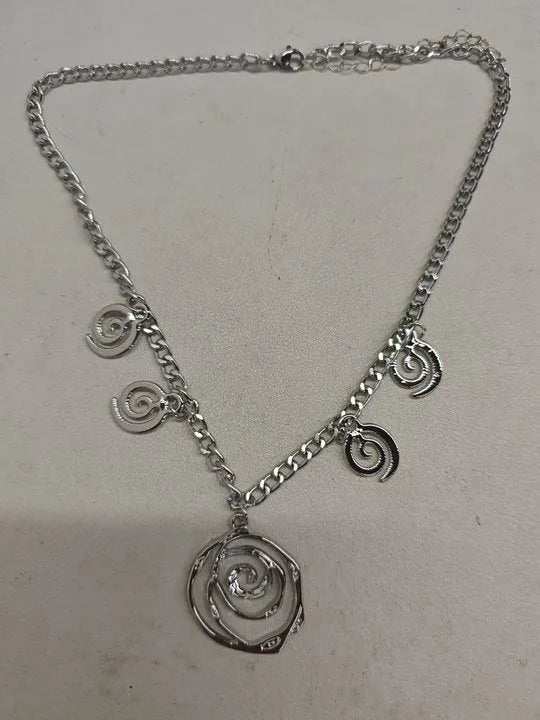 Spiral donut jewellery set showing necklace, bracelet and ear hooks with geometric circle designs in gold finish