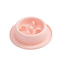 Pink pet slow feeder bowl with maze pattern for dogs and cats on a non-slip mat.