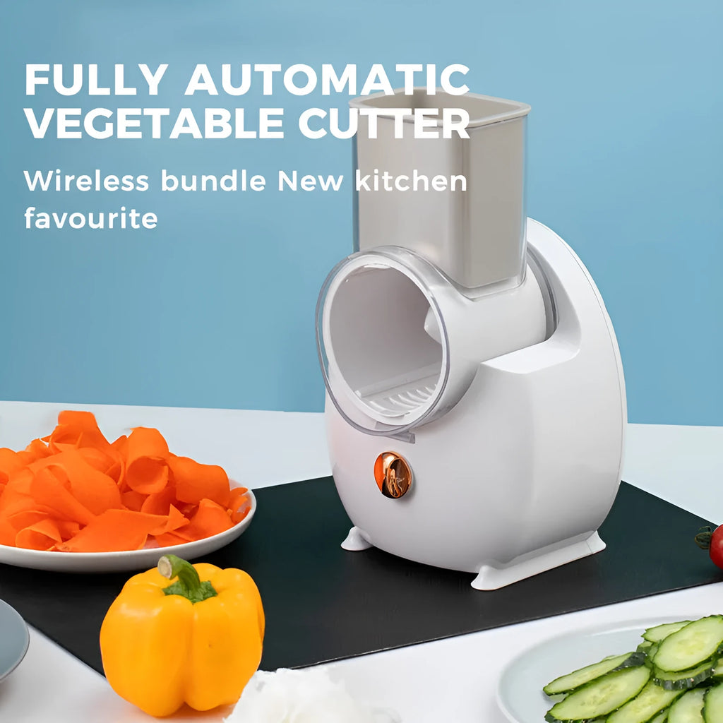 White electric vegetable slicer with suction base, feeding port, pressing rod, and multiple blades on a kitchen counter.