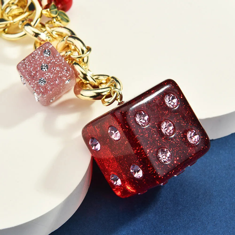 Vintage-style metal keychain with a square cherry red and white two-tone dice pendant on a metal ring.