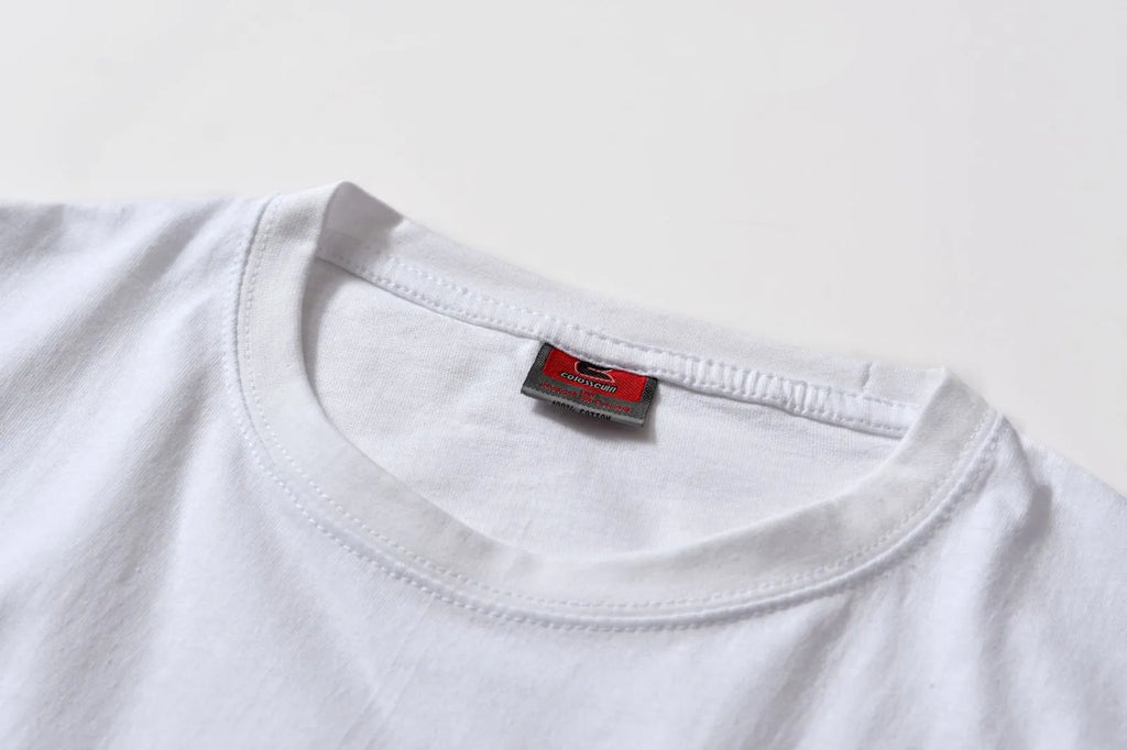 White patterned cotton pullover top with short sleeves on a hanger
