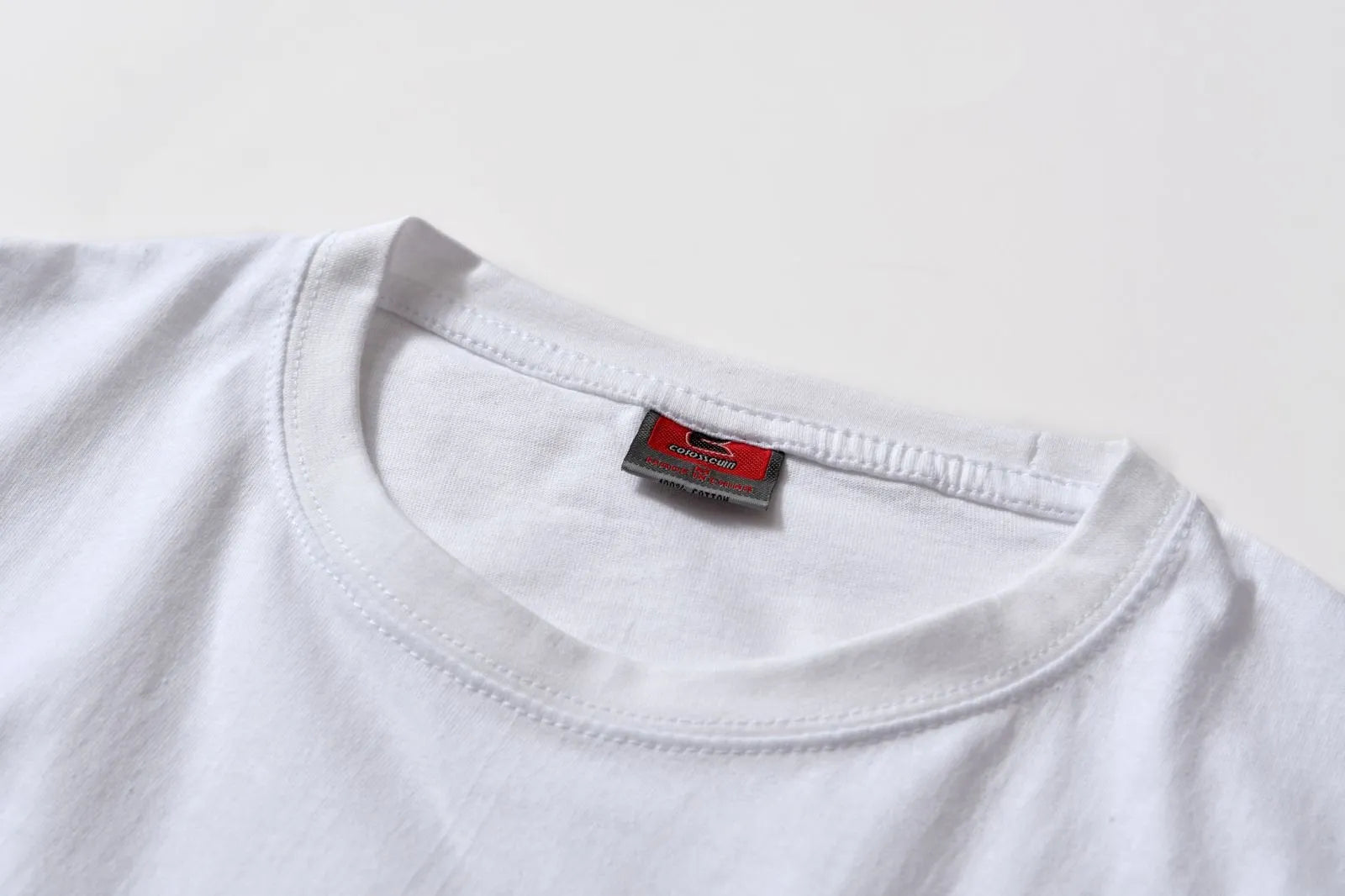 White patterned cotton pullover top with short sleeves on a hanger