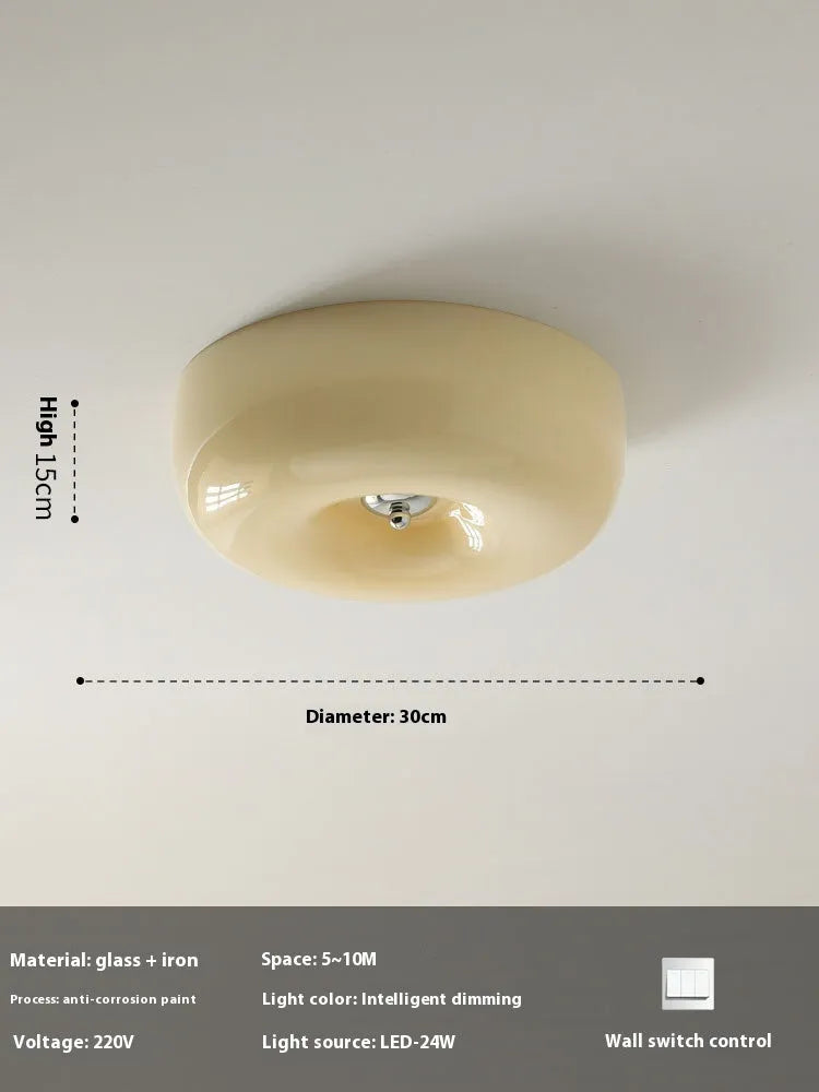 American style cream coloured bedroom ceiling light with a remote control on a white background.