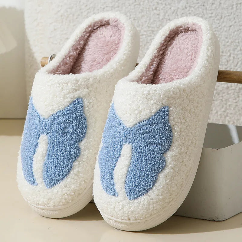Pink and blue cotton suede slippers with a cartoon bow knot design and TPR sole.