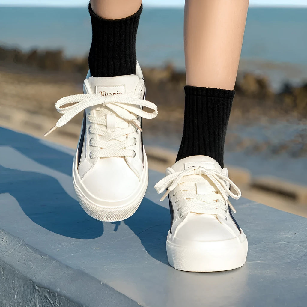 Women's blue and white low-top board shoes with vulcanised rubber soles and lace-up front.