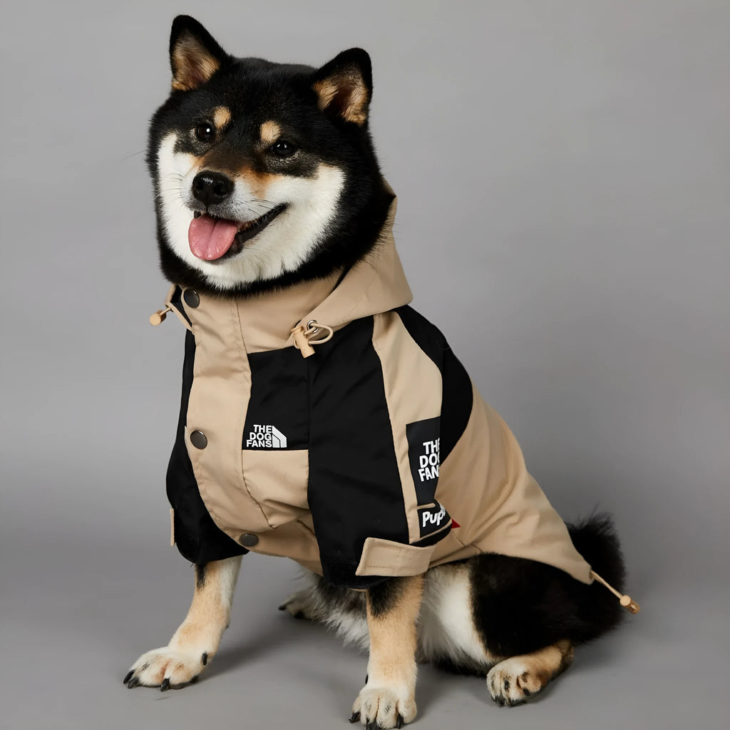 Khaki coloured polyester shell jacket for a dog on a white background.