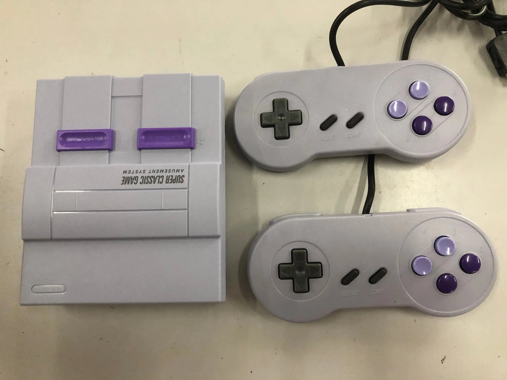 SNES mini game console replica in black with two wired controllers and HDMI cable