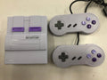 SNES mini game console replica in black with two wired controllers and HDMI cable
