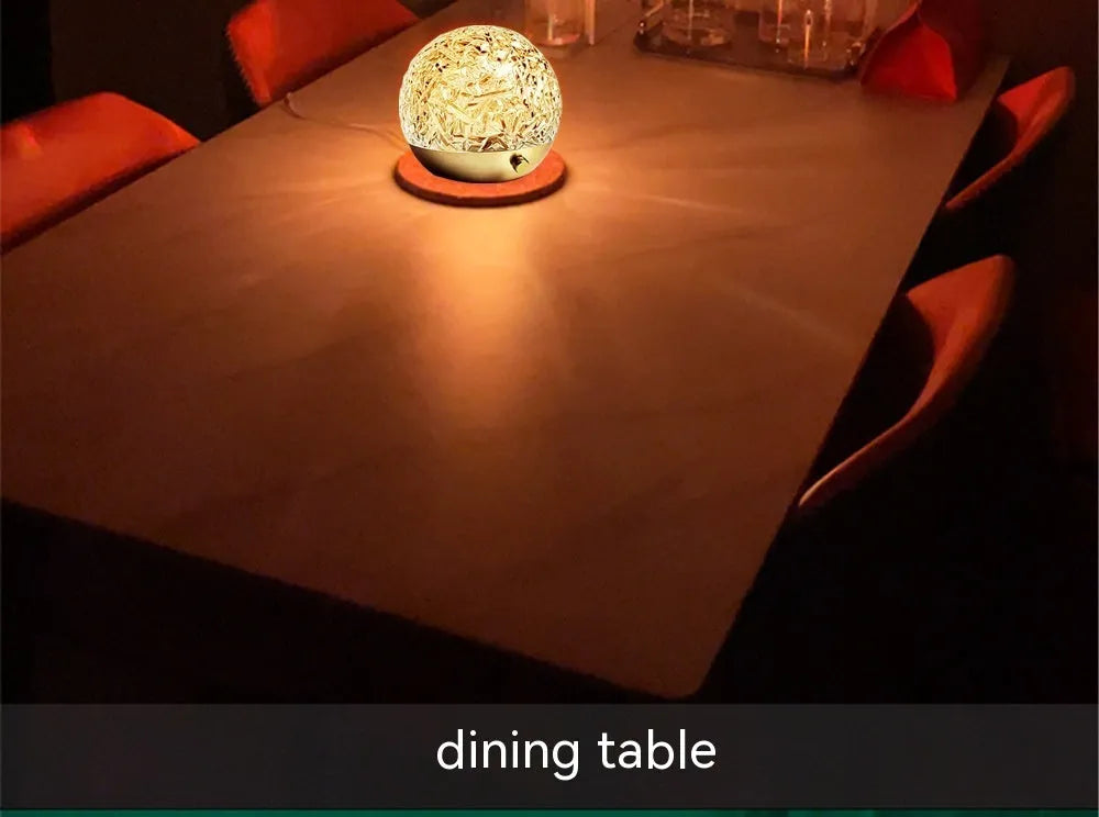 Water ripple projector night light with crystal-like acrylic body and colourful ripple patterns on a bedside table
