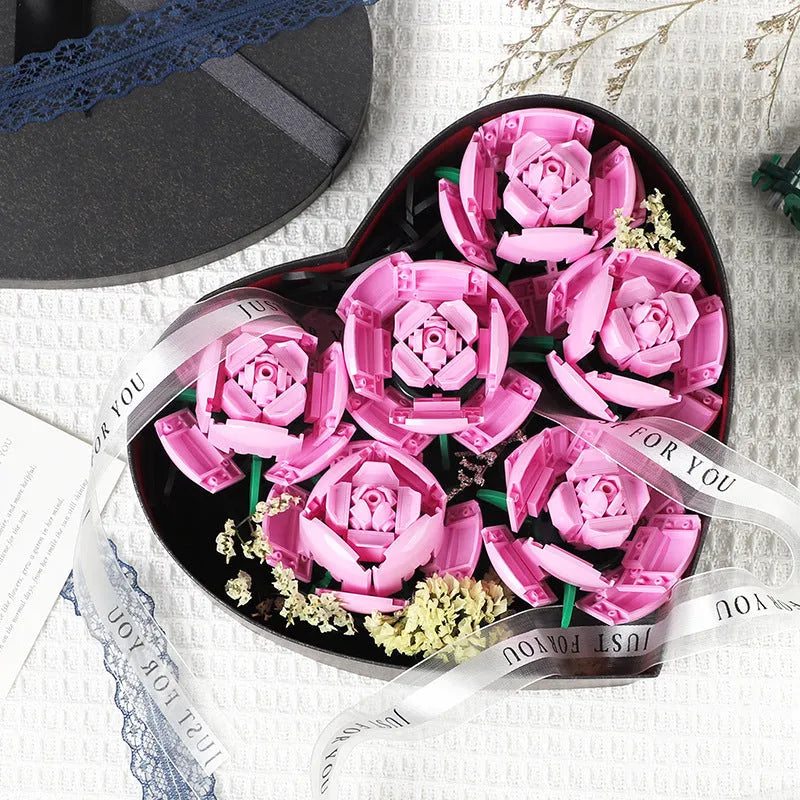 Rose assembled from small particle plastic building blocks in pink, red, or blue