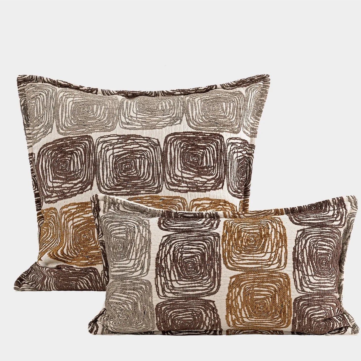 Cream and coffee coloured abstract coil pattern square and rectangular polyester cushion covers.