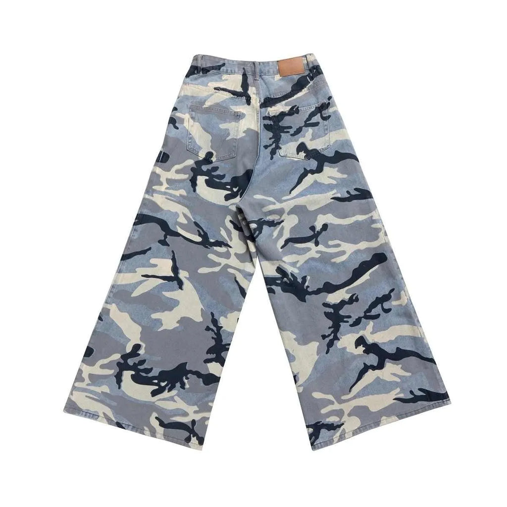 A pair of loose-fit blue jeans with a snow camouflage pattern on a mannequin.