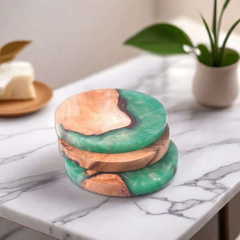 Set of solid colour resin coasters in black and green, showing round and square shapes on a wooden table.