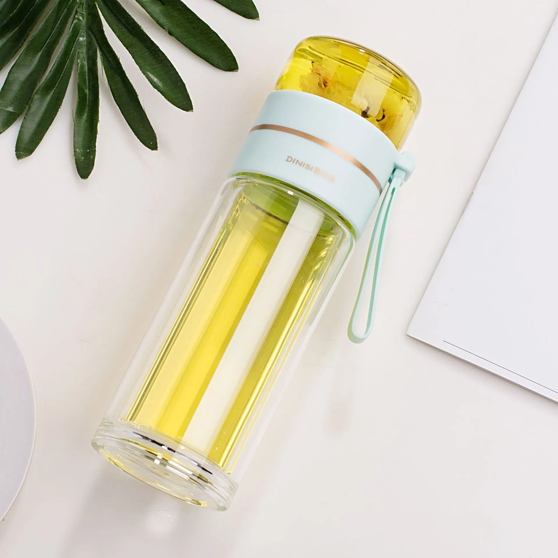 Glass water bottle with tea infuser filter showing double wall construction and portable rope