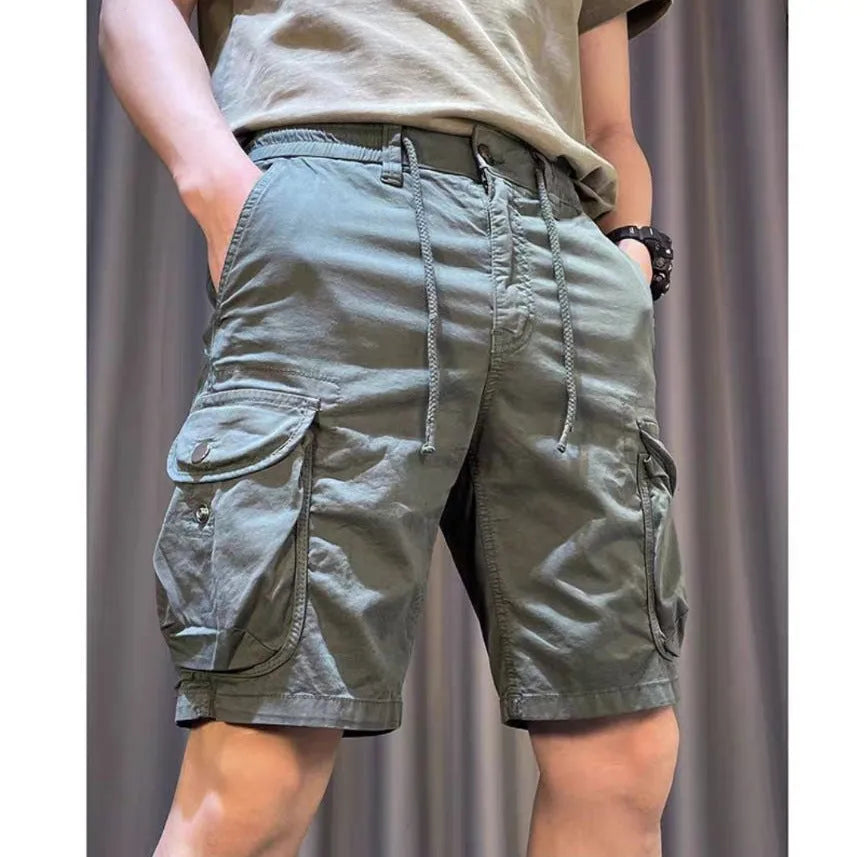 Korean style loose straight leg overalls trousers in khaki with multiple pockets, shown on a model.