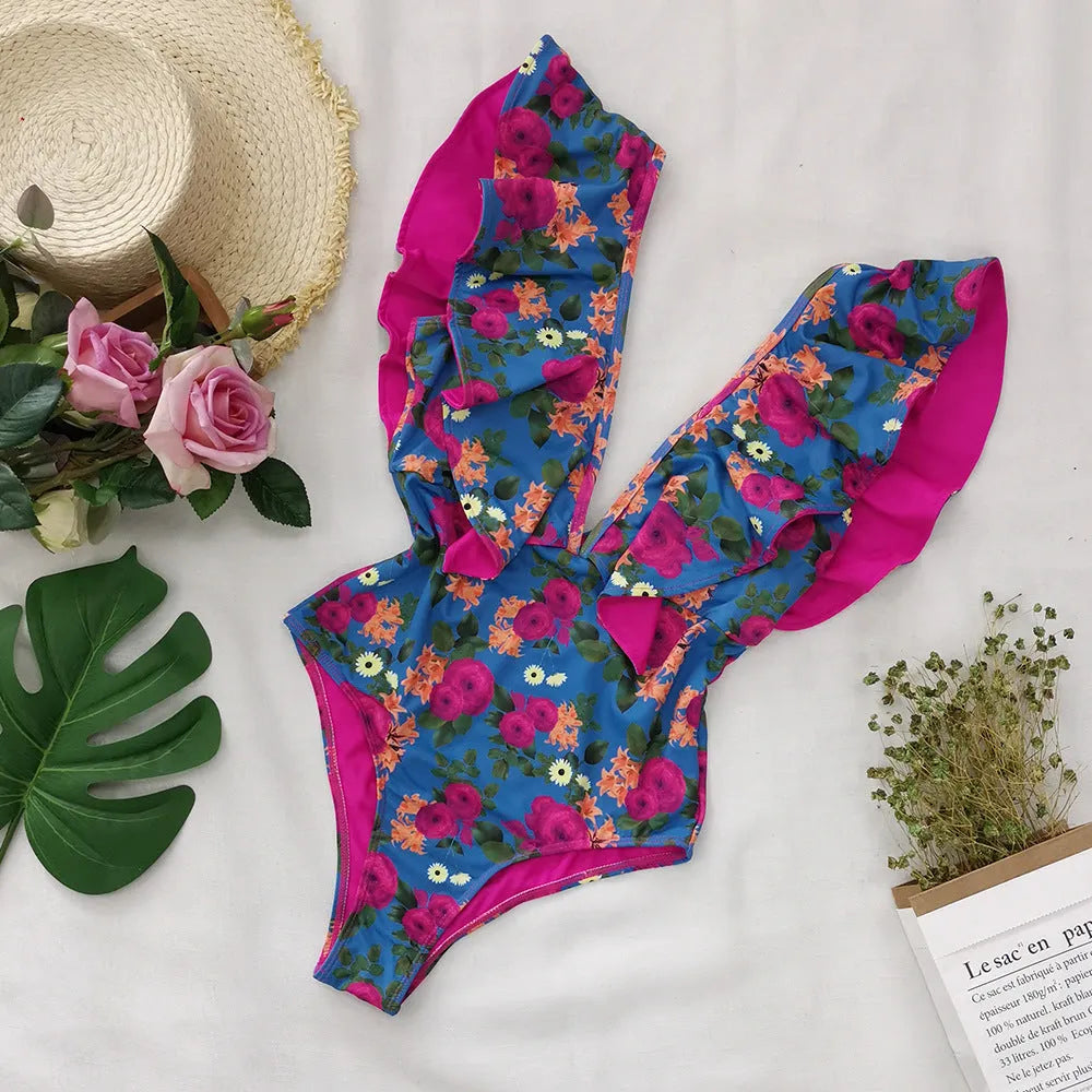 Blue printed one-piece swimsuit for women with one-shoulder ruffle and chest pad on white background