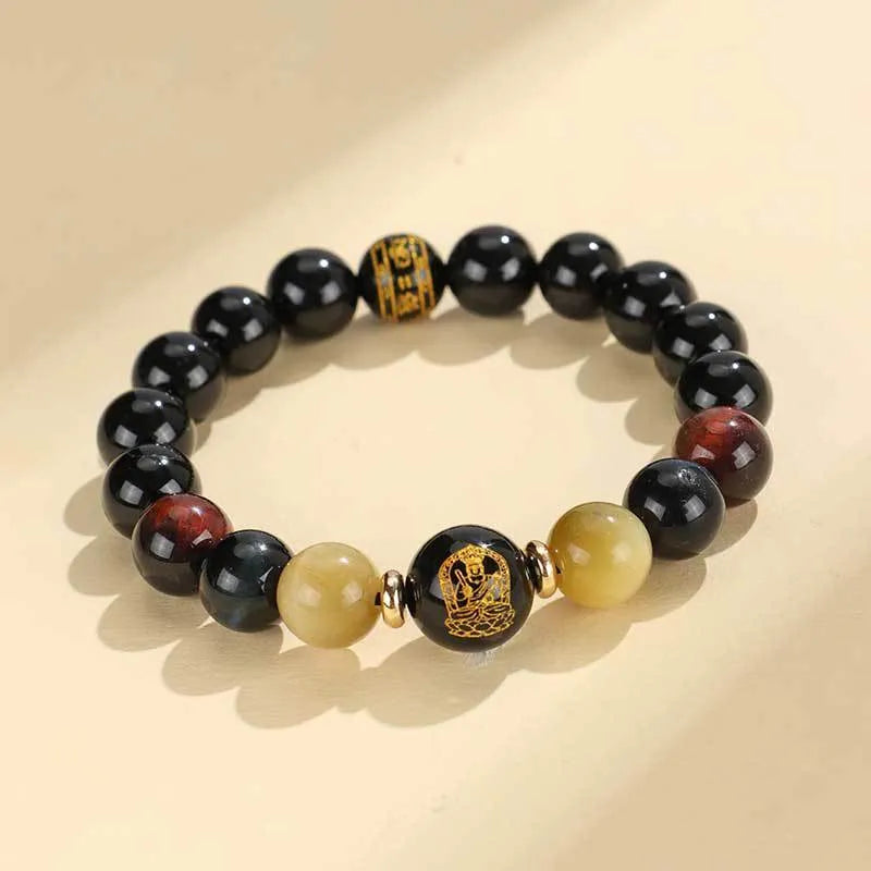Handmade black agate beaded bracelet with gold, blue, and red tiger eye stones featuring Buddhist deity and zodiac animal motifs.