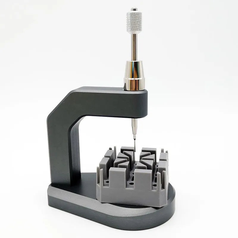 Silver-coloured tool steel press strap removal tool for watches and jewellery.