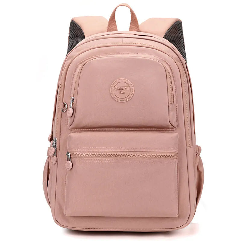 Women's waterproof nylon travel backpack with multi-compartments in rose red colour showing organisational features