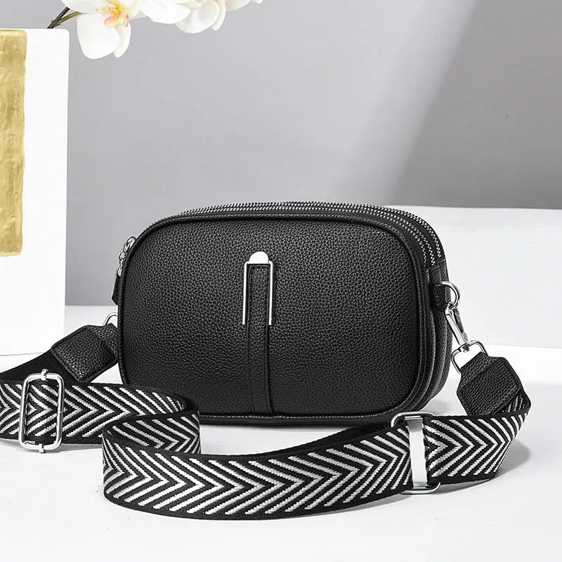 PU leather crossbody shoulder bag in oval shape with multiple internal compartments