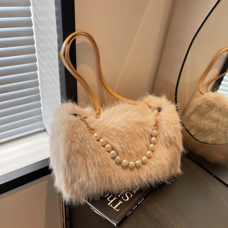 Plush shoulder bag with pearl chain, 27cm wide, shown in black for autumn winter commuting