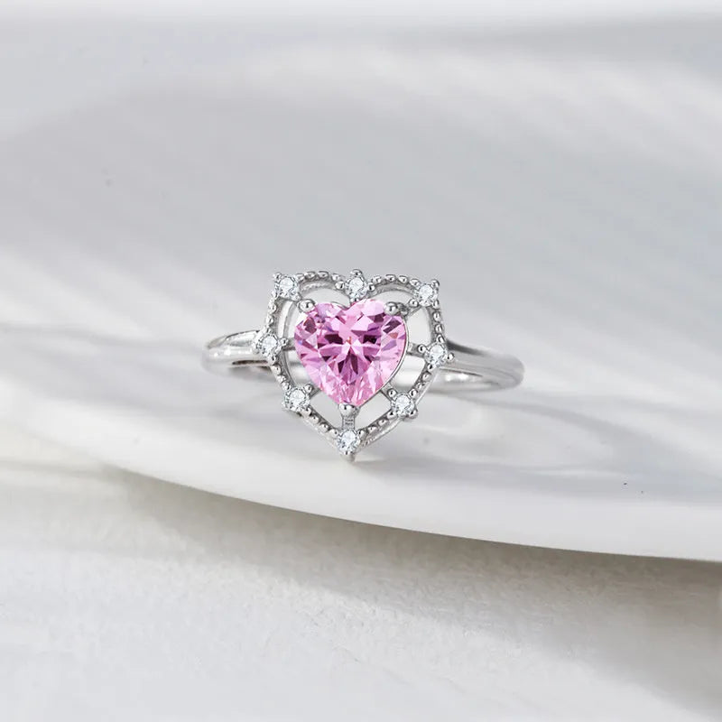 Silver heart-shaped ring with inlaid zircon and hollow-out band in white gold colour