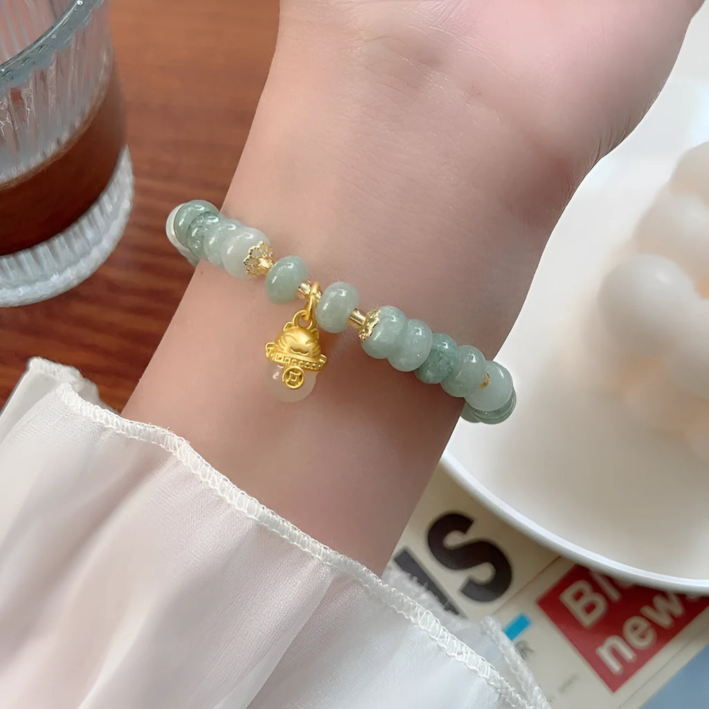Women's strawberry quartz bracelet with lucky cat charm and animal zodiac modelling in retro style