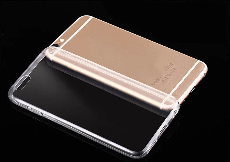 Transparent TPU soft shell protective case for various iPhone models on a table.