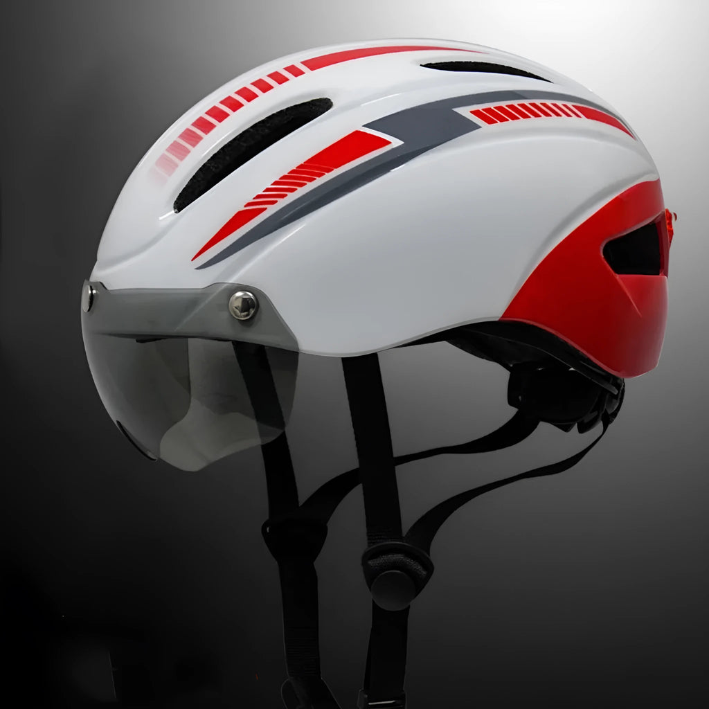 Adult bicycle helmet with integrated red taillight on back and a pair of black sports goggles, shown in a black and blue colour scheme.