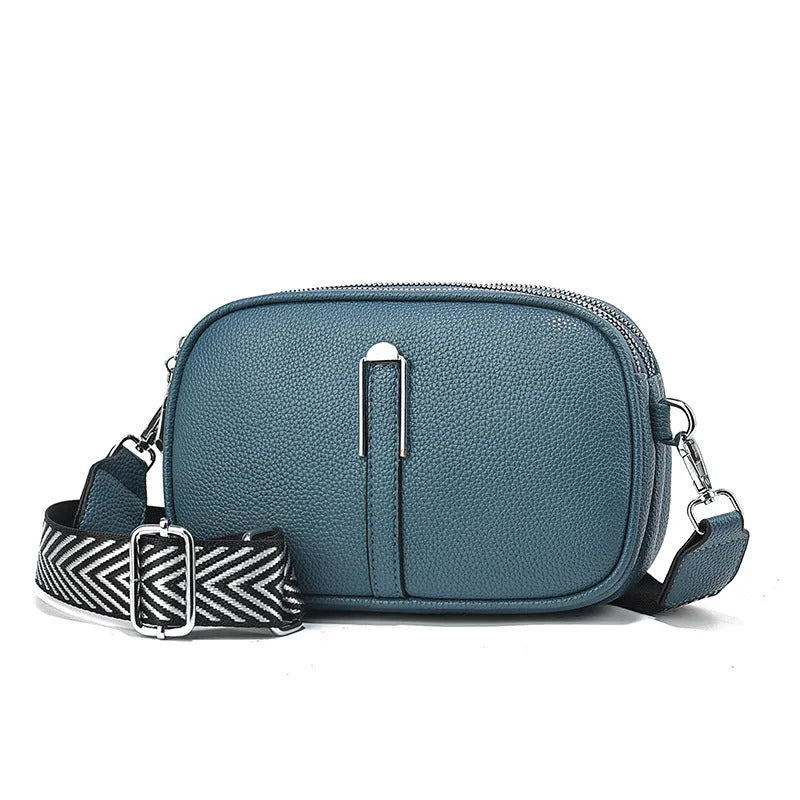 PU leather crossbody shoulder bag in oval shape with multiple internal compartments