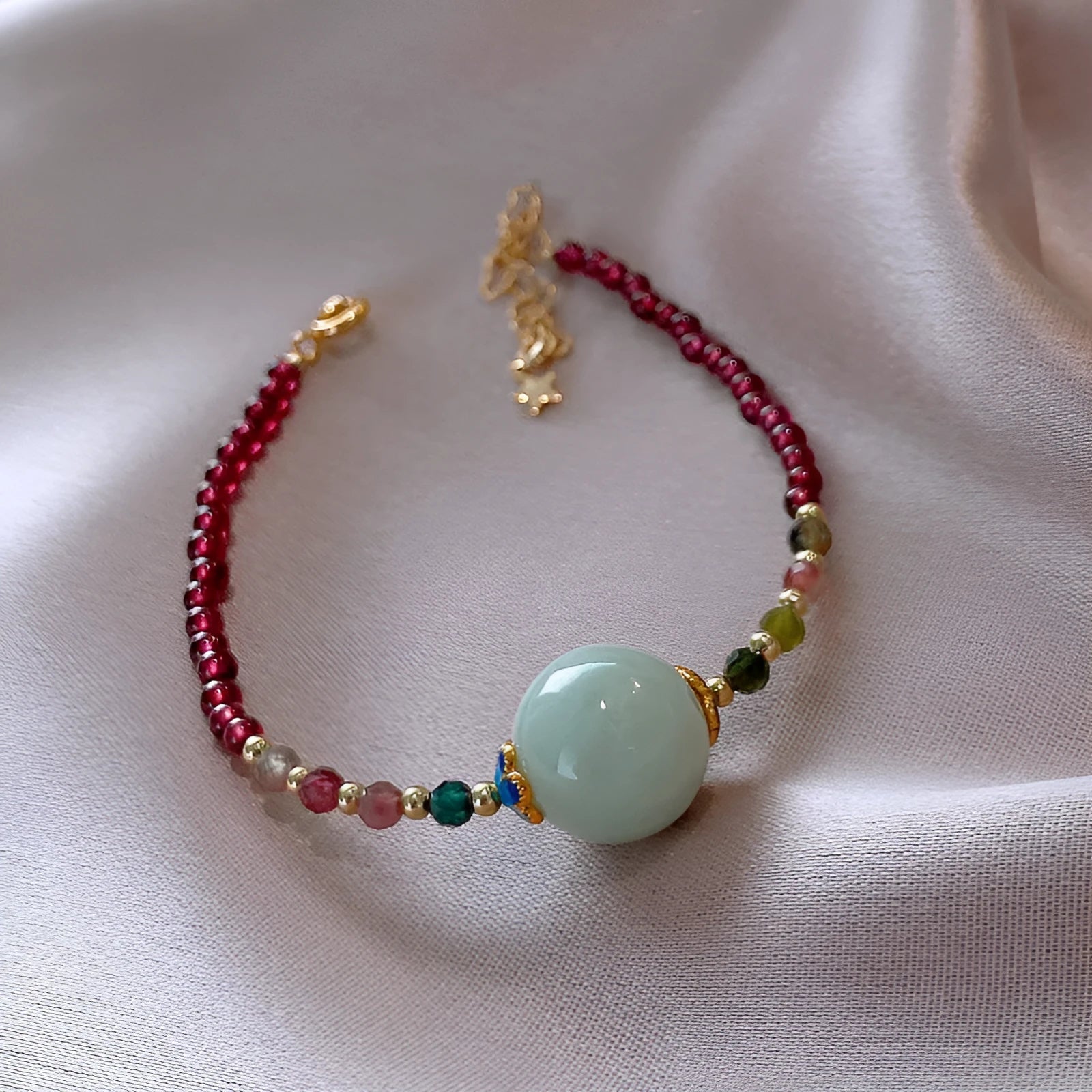 Women's aquamarine and garnet bracelet with drop shape stones and electroplated tourmaline elements