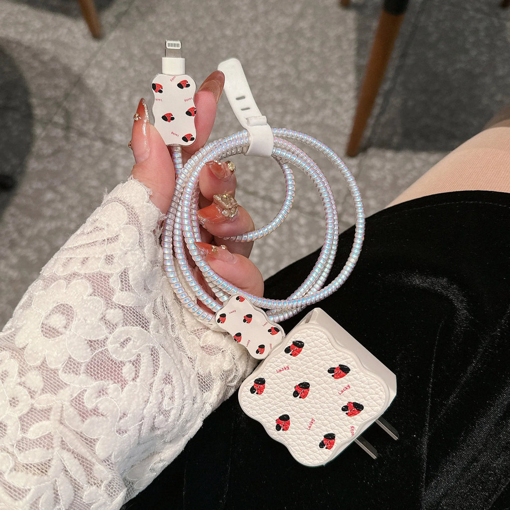 Lambskin USB cable protection sleeve in a cartoon puppy pattern, shown on a charging cable.