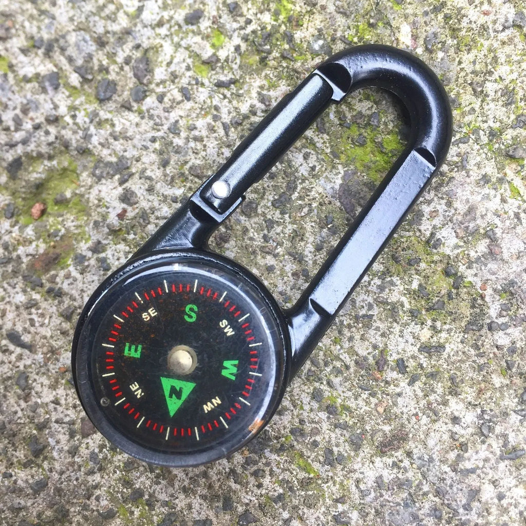 Black zinc alloy double-sided carabiner with a climbing button closure, showing integrated compass and thermometer.