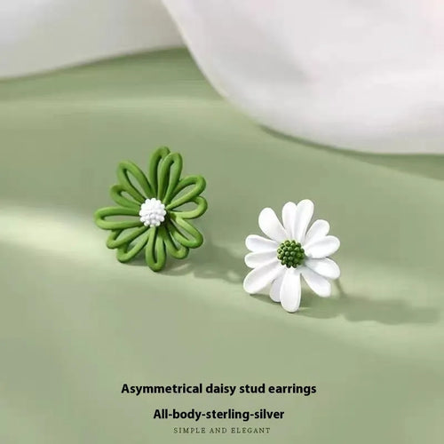 Close-up of colourful alloy flower stud earrings showing white and green two-tone design.