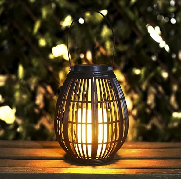 Oval rattan-style solar garden light in retro design for outdoor patio use.